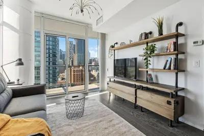 a living room with a couch and a large window at Amazing View 2BR St Lawrence Market Condo, Downtown Toronto in Toronto