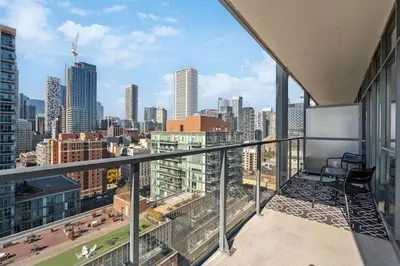 an apartment balcony with a view of a city at Amazing View 2BR St Lawrence Market Condo, Downtown Toronto in Toronto