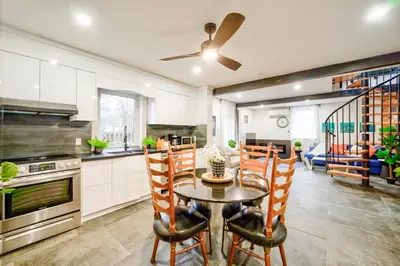 a kitchen and dining room with a table and chairs at Moon River in Campbellford