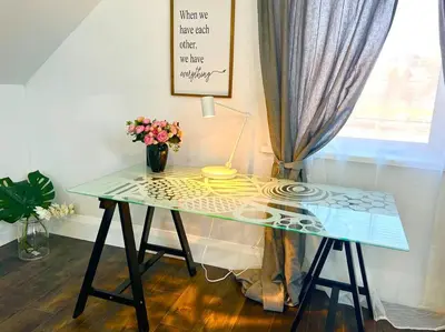 a glass table with a vase of flowers and a lamp at Moon River in Campbellford