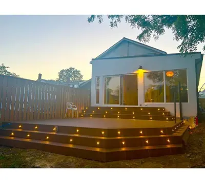a house with a bench with lights on it at River Runs Through It in Belleville