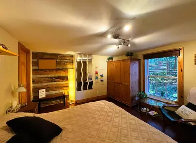 a bedroom with a large bed and a window at The Cozy Corner in Elora