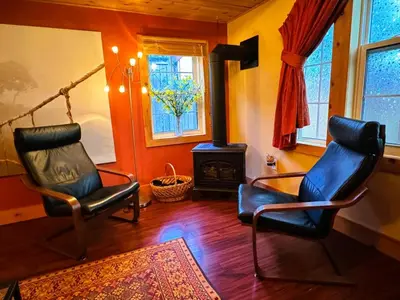 two chairs in a living room with a stove at The Cozy Corner in Elora