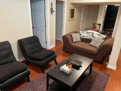 a living room with a couch and a chair at Cozy 2BR Basement Near Two Lakes in Richmond Hill