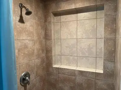 a shower with a shower head in a bathroom at Cozy 2BR Basement Near Two Lakes in Richmond Hill