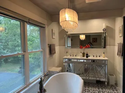 a bathroom with a tub and a sink and a window at Luxury and comfy Home- Niagara getaway in Niagara Falls