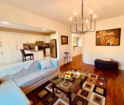 a living room with a couch and a table at Charming Family Getaway in Richmond Hill in Richmond Hill