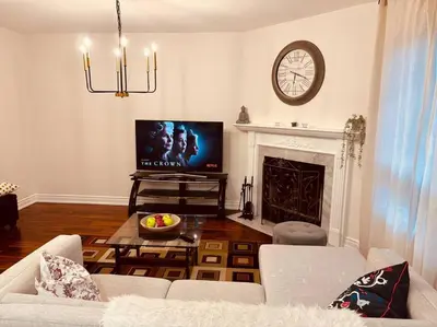 a living room with a couch and a fireplace at Charming Family Getaway in Richmond Hill in Richmond Hill