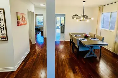 a dining room and a living room with a table at Charming Family Getaway in Richmond Hill in Richmond Hill