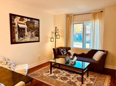 a living room with a couch and a coffee table at Charming Family Getaway in Richmond Hill in Richmond Hill