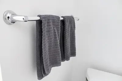 a towel rack with three towels hanging on a wall at City View Towers - Steps to CN Tower - Indoor Pool - Save on 4 weeks stay in February in Toronto