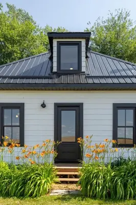a house with black windows and a black door at Carson's Creek in Hillier