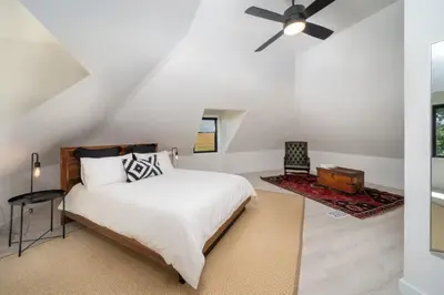 a bedroom with a bed and a ceiling fan at Carson's Creek in Hillier