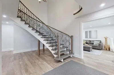 a staircase in a living room with a couch at Newly renovated luxury villa in Stouffville, ON in Stouffville