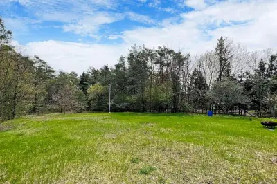 a field of green grass with trees in the background at Newly renovated luxury villa in Stouffville, ON in Stouffville