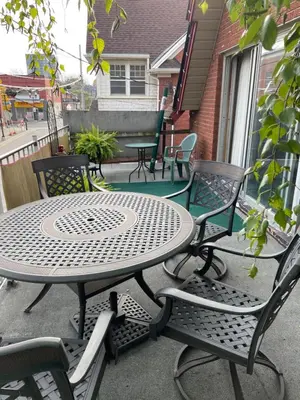 a table and chairs sitting on a patio at Big apartment by the Farmers market in Kitchener