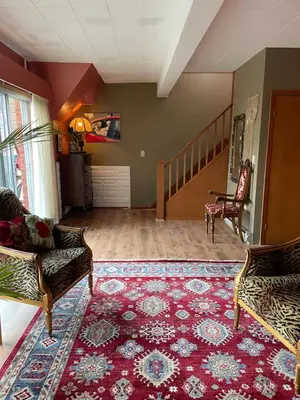 a living room with two chairs and a rug at Big apartment by the Farmers market in Kitchener