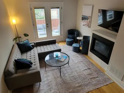 a living room with a couch and a coffee table at Cozy 3BR Retreat with Dedicated Work table and Parking in Toronto