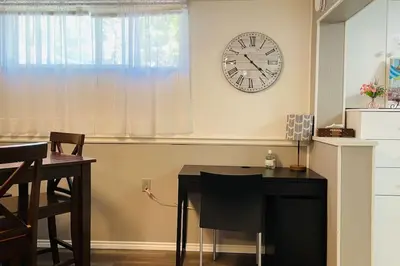 a room with a table and a clock on the wall at 2 bedroom rental apartment , 1 sofa bed, 2 car parking in Mississauga