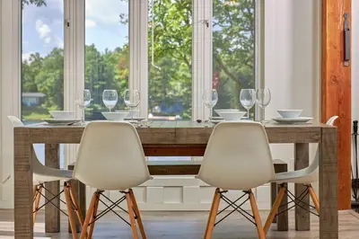 a dining room with a table with wine glasses at Muskoka Retreat, Fire Pit, Games, Waterfront in Gravenhurst