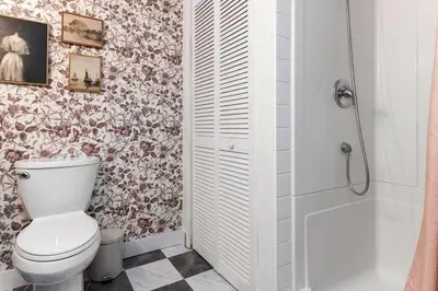 a white bathroom with a toilet and a shower at 4Bdrm Muskoka Retreat, Fire Table, Games, Netflix in Port Carling