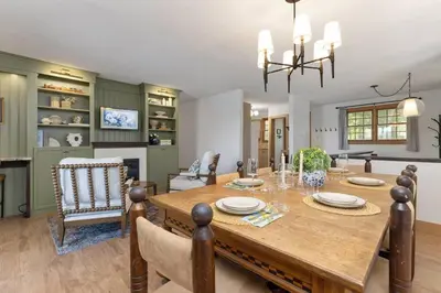 a kitchen and dining room with a wooden table and chairs at 4Bdrm Muskoka Retreat, Fire Table, Games, Netflix in Port Carling