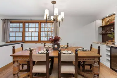 a dining room with a wooden table and chairs at 4Bdrm Muskoka Retreat, Fire Table, Games, Netflix in Port Carling