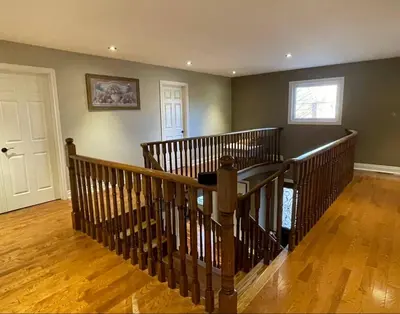 a staircase in a home with a wooden floor at Family-Friendly Retreat for 14 in Richmond Hill in Richmond Hill
