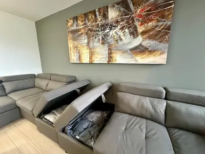 a living room with a couch and a painting on the wall at Corner suite Courtyard view 4 real beds in Toronto