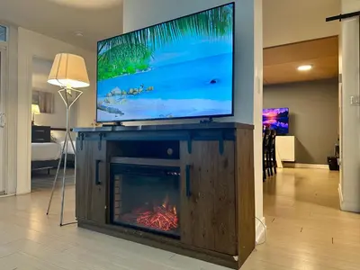 a living room with a fireplace with a tv on top of it at Corner suite Courtyard view 4 real beds in Toronto