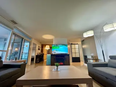 a living room with a couch and a coffee table at Corner suite Courtyard view 4 real beds in Toronto