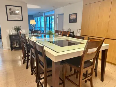 a kitchen and dining room with a table and chairs at Corner suite Courtyard view 4 real beds in Toronto