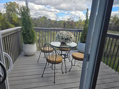 a patio with a table and chairs on a deck at Beautiful House 2 bedroom in Belleville