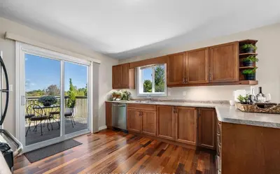 a kitchen with wooden cabinets and a view of a patio at Beautiful House 2 bedroom in Belleville