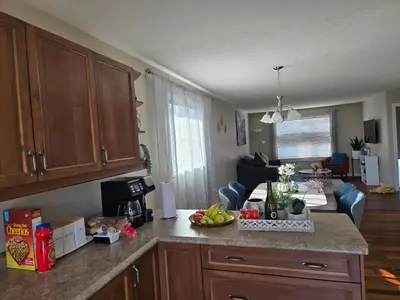 a kitchen with a counter top and a living room at Beautiful House 2 bedroom in Belleville