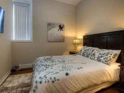 a bedroom with a large bed and a window at Western Hotel & Executive Suites in Guelph