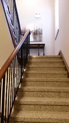 a staircase in a building with brown stairs at Western Hotel & Executive Suites in Guelph