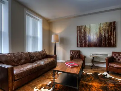a living room with a couch and a table at Western Hotel & Executive Suites in Guelph