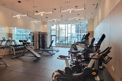a gym with several treadmills and cardio machines at Lakeview Escape Endy KING BED in Pickering