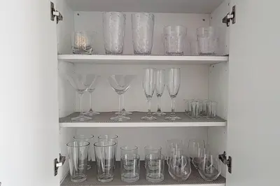a cupboard filled with lots of empty wine glasses at Lakeview Escape Endy KING BED in Pickering