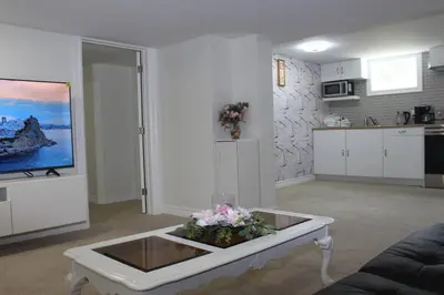 a living room with a coffee table with flowers on it at Exclusive Private Basement in London