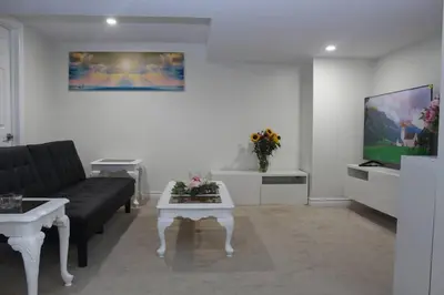a living room with a couch and a table at Exclusive Private Basement in London