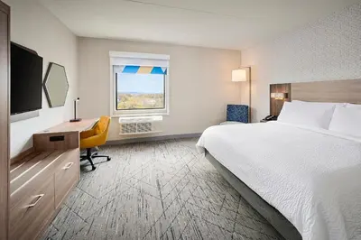 a hotel room with a bed and a desk and a window at Holiday Inn Express Hamilton - Upper James by IHG in Hamilton