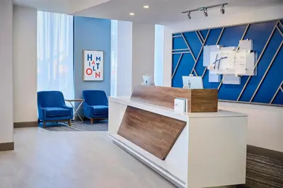 a waiting room with blue chairs and a counter at Holiday Inn Express Hamilton - Upper James by IHG in Hamilton