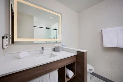 a white bathroom with a sink and a mirror at Holiday Inn Express Hamilton - Upper James by IHG in Hamilton