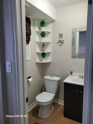 a bathroom with a white toilet and a sink at Home away from home in Brampton