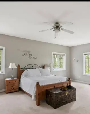 a bedroom with a bed and a ceiling fan at Summer Getaway with Pool and Nearby Attractions in Cobourg