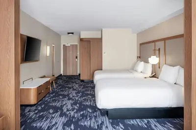 a hotel room with two beds and a television at Fairfield by Marriott Inn & Suites Gravenhurst Muskoka in Gravenhurst