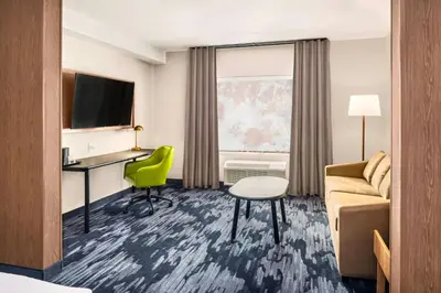 a hotel room with a couch and a desk at Fairfield by Marriott Inn & Suites Gravenhurst Muskoka in Gravenhurst
