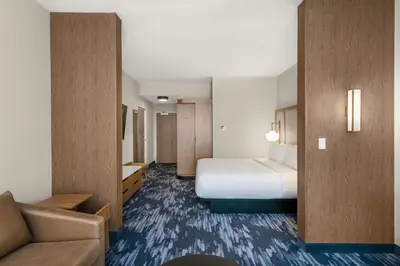 a hotel room with a bed and a couch at Fairfield by Marriott Inn & Suites Gravenhurst Muskoka in Gravenhurst